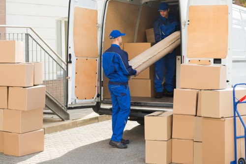 Furniture collection team handling bulky items in a Merton residential street