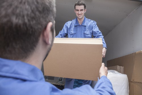 Man and van team loading furniture for a local move in Merton