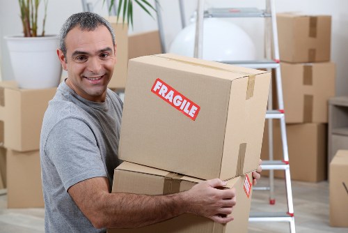 Man with van loading boxes for a local move in Merton