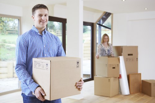 Professional movers handling furniture in a Merton flat