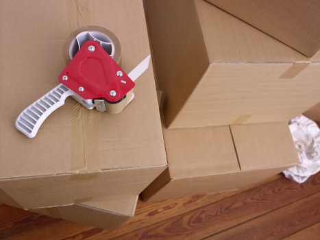 Professional movers handling boxes and furniture in Merton